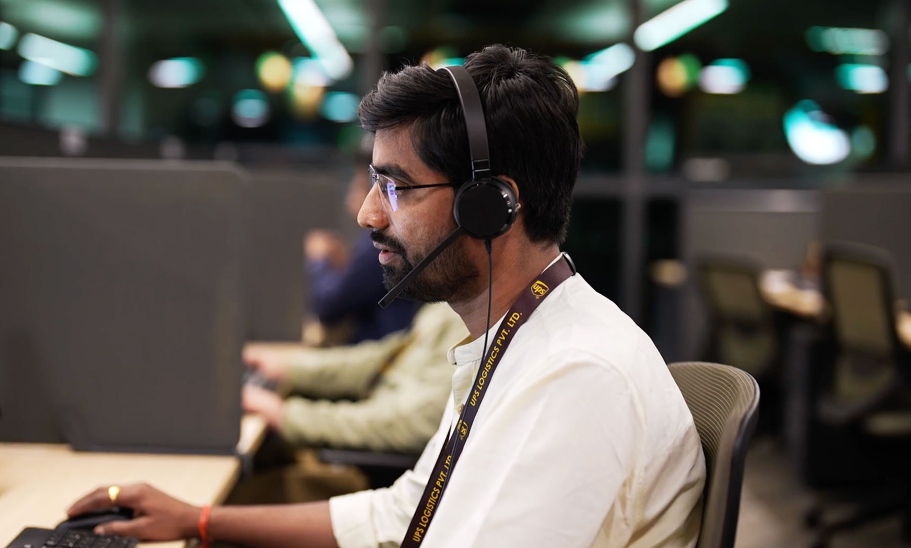 Agent on a headset call at a desk in a contact center
