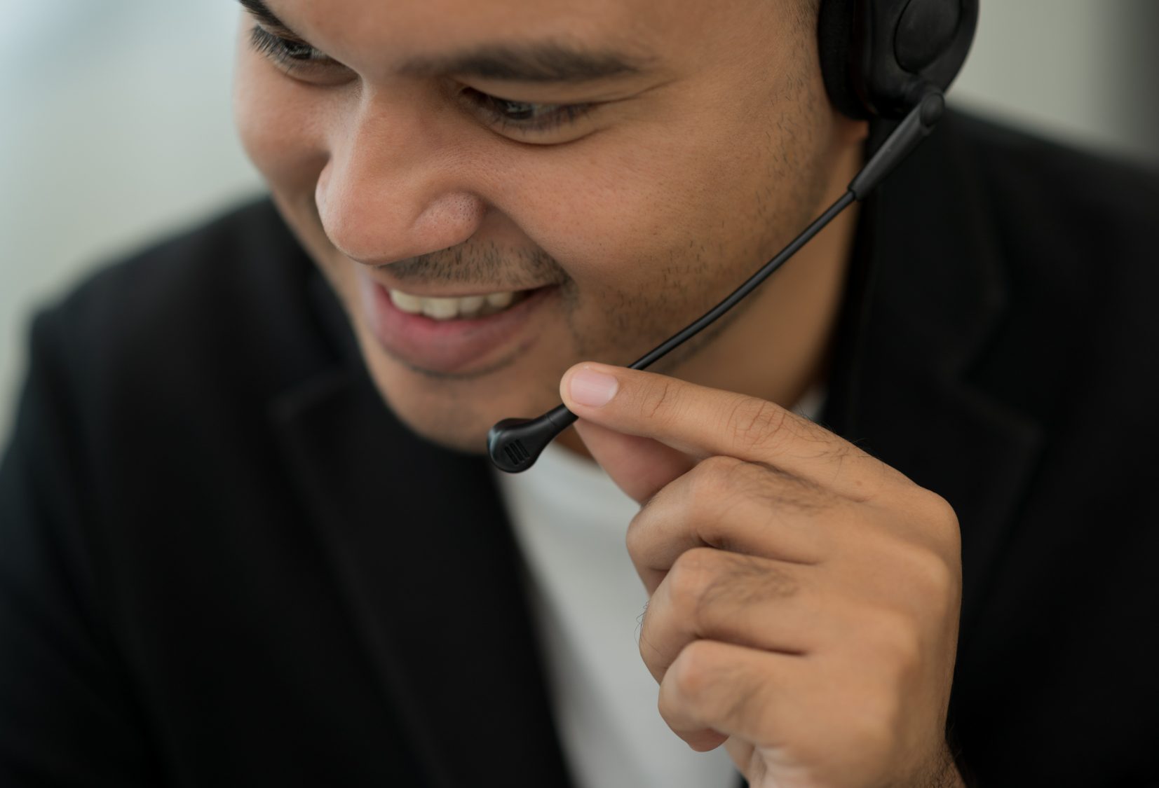 Customer service agent smiling on a headset call